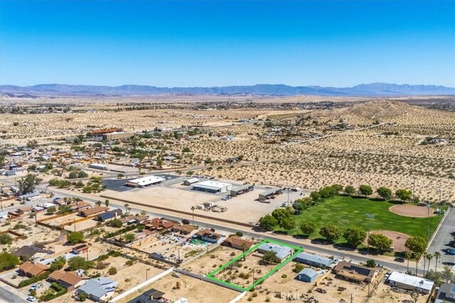 6818 El Sol Ave Unit 29, Palms, CA 92277 - aerial view of sparsely populated area with a desert landscape, mountains, and property parcel outlined