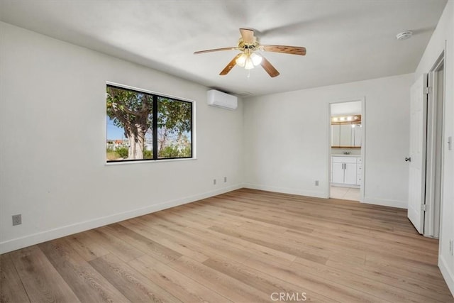 6818 El Sol Ave Unit 29, Palms, CA 92277 - unfurnished bedroom featuring a wall unit AC, light wood-style flooring, and baseboards