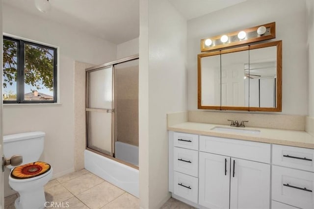6818 El Sol Ave Unit 29, Palms, CA 92277 - bathroom with toilet, vanity, combined bath / shower with glass door, tile patterned flooring, and baseboards