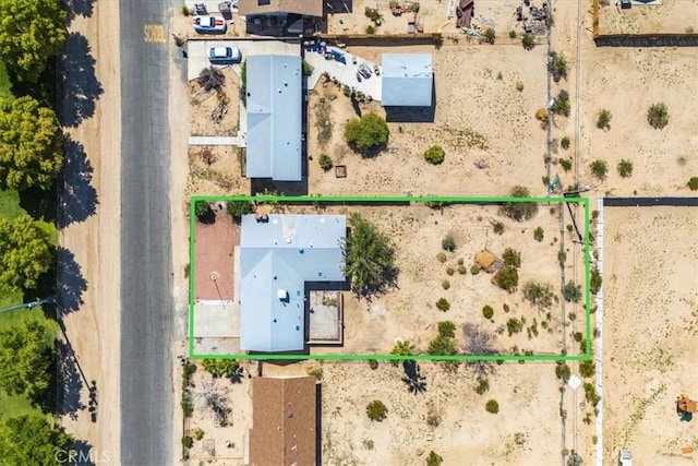 6818 El Sol Ave Unit 29, Palms, CA 92277 - aerial view of property and surrounding area featuring property parcel outlined and a desert landscape