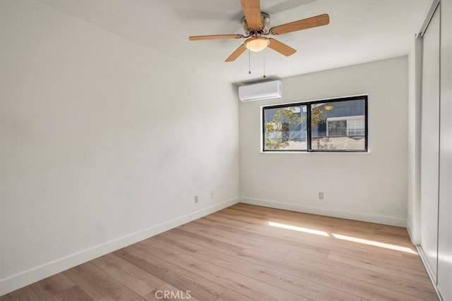 6818 El Sol Ave Unit 29, Palms, CA 92277 - spare room with a wall mounted air conditioner, baseboards, light wood-style floors, and ceiling fan