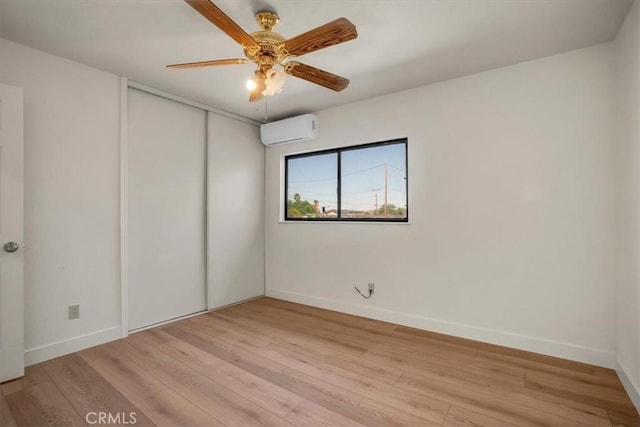 6818 El Sol Ave Unit 29, Palms, CA 92277 - unfurnished bedroom with an AC wall unit, light wood finished floors, and a closet