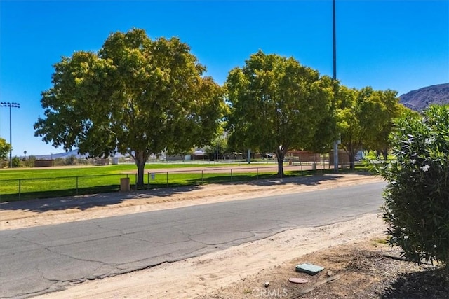 6818 El Sol Ave Unit 29, Palms, CA 92277 - view of asphalt road featuring a mountain view