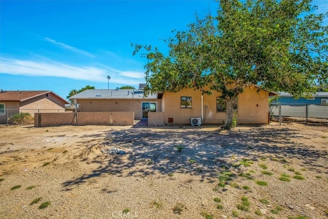 6818 El Sol Ave Unit 29, Palms, CA 92277 - back of house with stucco siding and fence