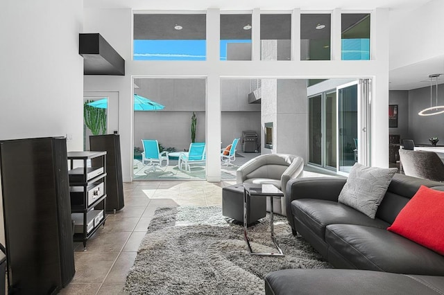 tiled living room featuring a high ceiling