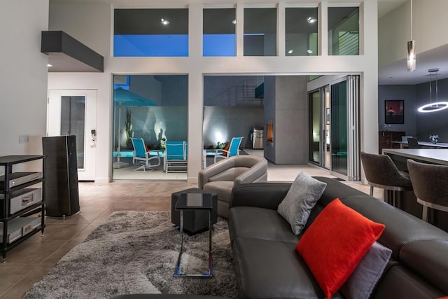 tiled living room featuring a high ceiling