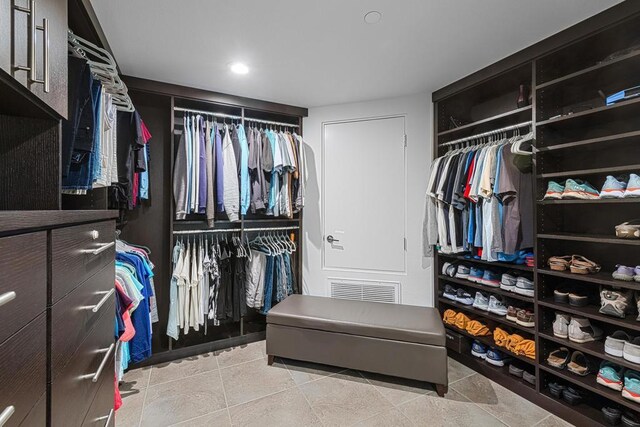 spacious closet featuring light tile patterned floors