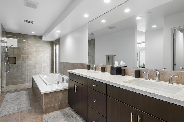 bathroom featuring tile patterned flooring, vanity, and separate shower and tub