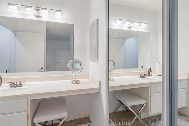 bathroom featuring tile patterned flooring and vanity