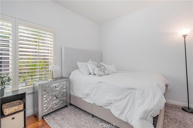 bedroom featuring light wood-style flooring and baseboards