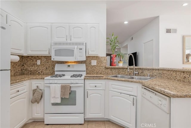 kitchen featuring white appliances, a sink, and white cabinetry