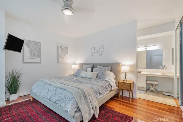 bedroom with ceiling fan and wood-type flooring