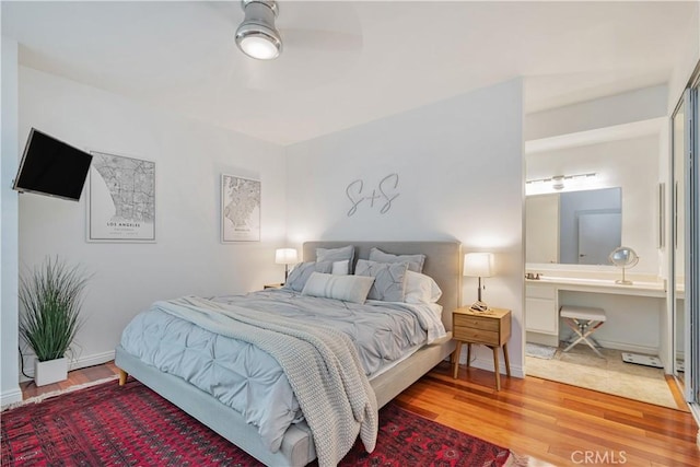 bedroom featuring baseboards and wood finished floors