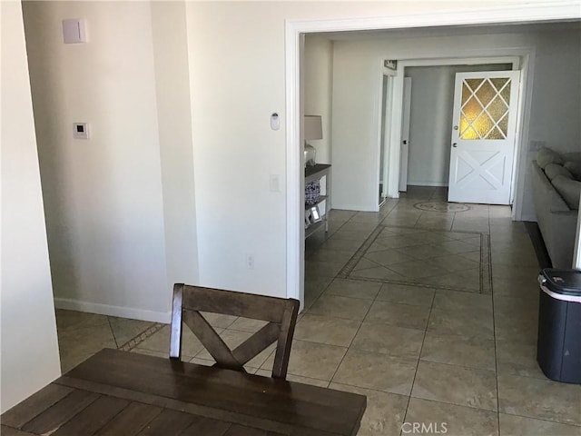 hallway with tile patterned floors