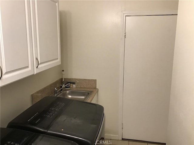 washroom featuring cabinets and sink