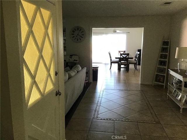 hallway featuring dark tile patterned floors