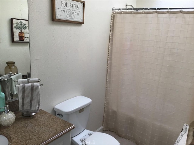 bathroom with vanity, toilet, and walk in shower