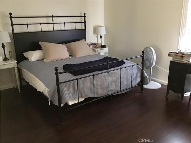 bedroom featuring dark hardwood / wood-style flooring