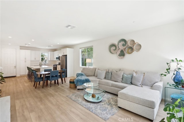 living room with light hardwood / wood-style floors