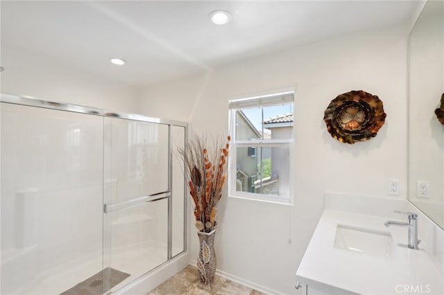 bathroom with vanity and a shower with door