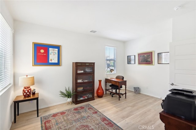 office space with light hardwood / wood-style flooring