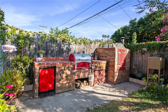 view of patio featuring exterior kitchen and grilling area