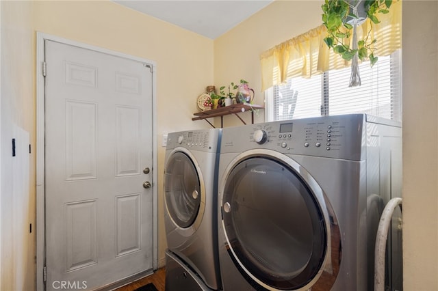 washroom with washer and clothes dryer and dark hardwood / wood-style flooring