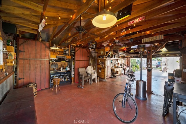 interior space with wood walls and ceiling fan