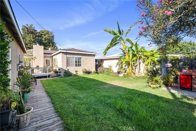 view of yard featuring a wooden deck