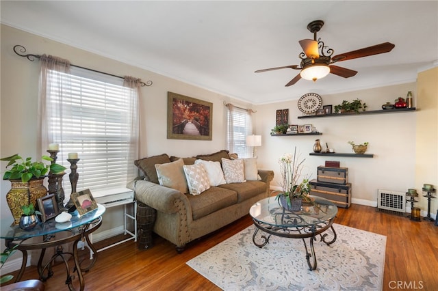 living room with a healthy amount of sunlight, ceiling fan, and dark hardwood / wood-style floors