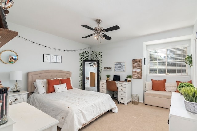 bedroom with ceiling fan and light carpet