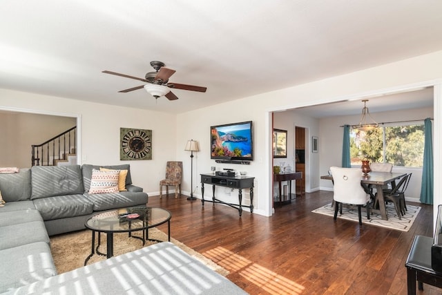 living room featuring ceiling fan and dark hardwood / wood-style flooring