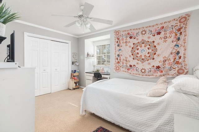 bedroom with ceiling fan, a closet, light carpet, and ornamental molding