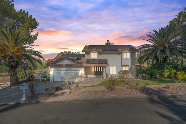 view of front of home featuring a garage and solar panels