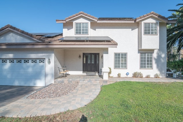 view of front of home with a front yard and a garage