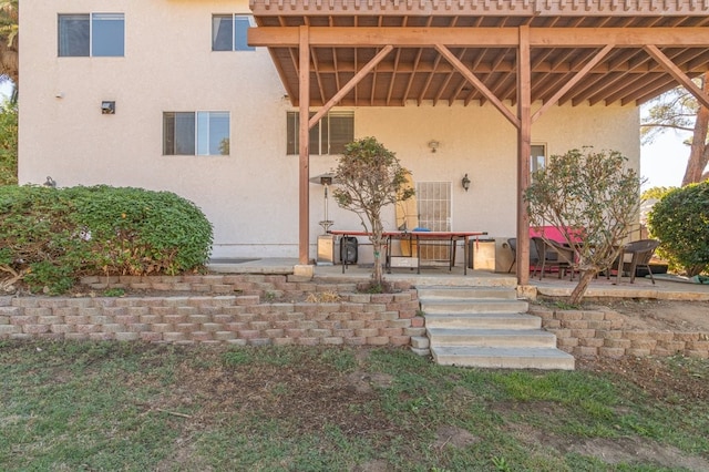 doorway to property with a patio area