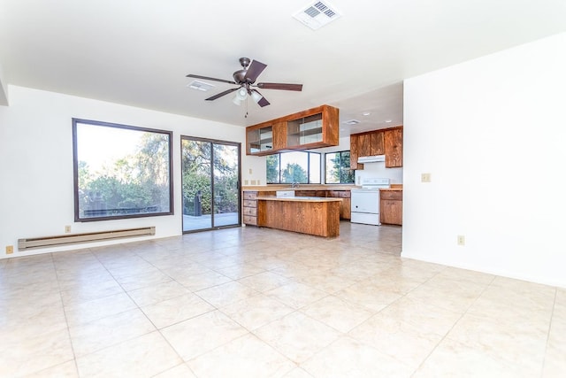 kitchen featuring range, kitchen peninsula, light tile patterned floors, ceiling fan, and a baseboard heating unit