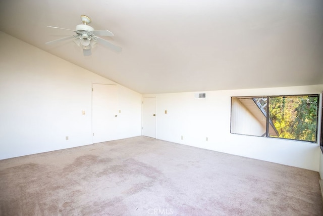 carpeted empty room featuring lofted ceiling and ceiling fan