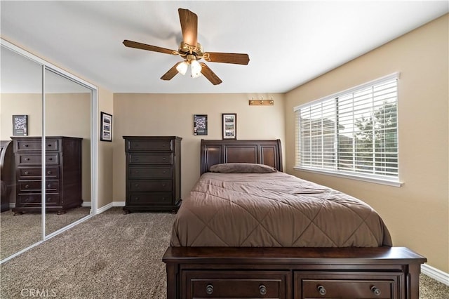 bedroom featuring ceiling fan, dark carpet, and a closet