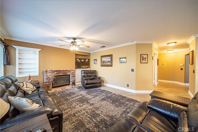 tiled living room with a brick fireplace, built in shelves, crown molding, and ceiling fan