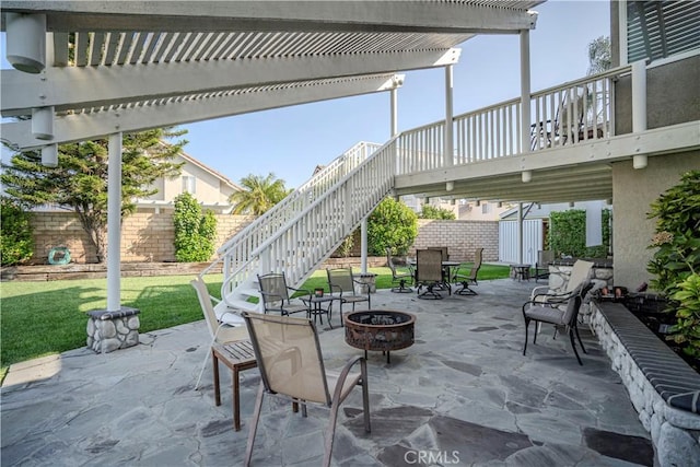 view of patio / terrace with an outdoor fire pit and a pergola