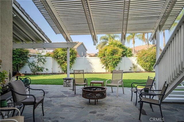 view of patio featuring an outdoor fire pit and a pergola