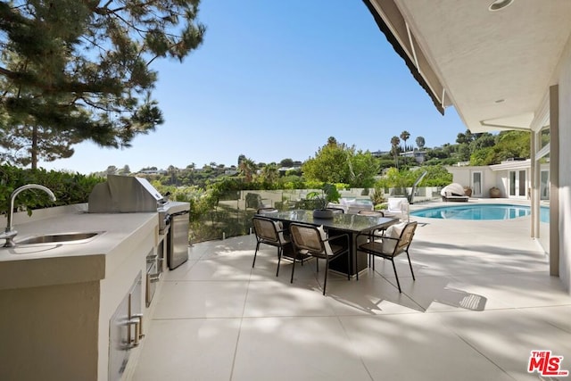 view of patio / terrace with sink and exterior kitchen