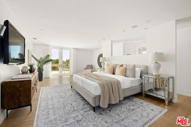 bedroom with light hardwood / wood-style flooring, access to outside, and french doors