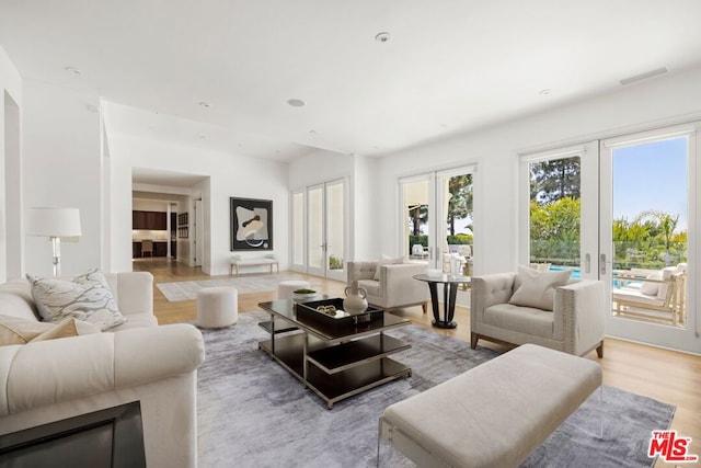 living room featuring light wood-type flooring and french doors