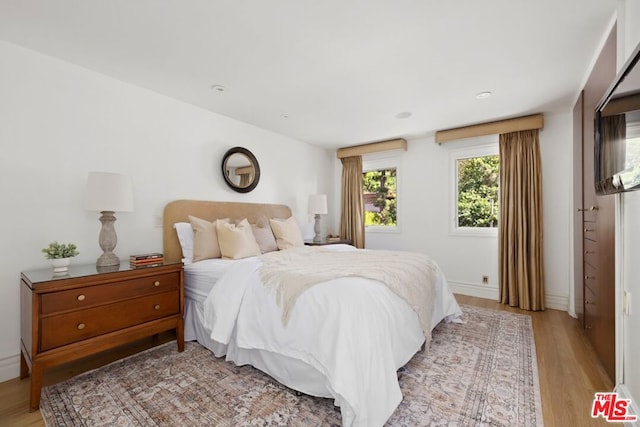 bedroom with light hardwood / wood-style floors