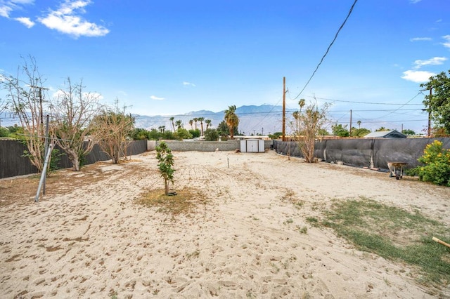 view of yard with a mountain view and a storage unit