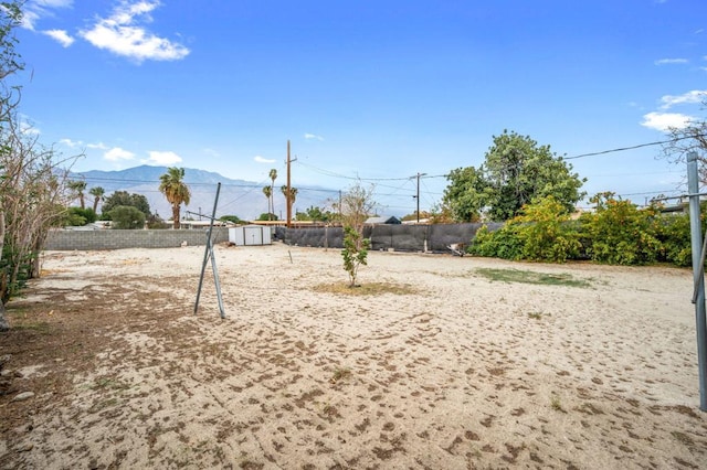 view of yard with a mountain view and a storage unit