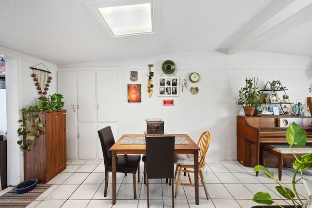 tiled dining room featuring lofted ceiling with beams