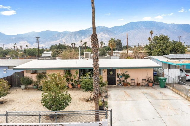 single story home featuring central AC unit and a mountain view